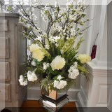 D02. Mirrored vase with faux flowers. 